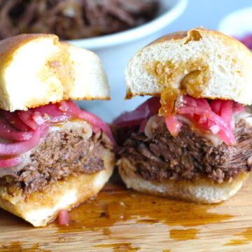 Pulled Beef Brisket Sandwich made in the Slow Cooker is smokey, savory, tender, moist, and full of flavor. In a delicious sauce, it goes great on a sandwich, over polenta, on rice, or potatoes. #slowcooker #crockpot #brisket #beefbrisket #pulledbeef #pulledpork
