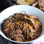 Pulled Beef Brisket in a bowl and in the Slow Cooker is smokey, savory, tender, moist, and full of flavor. In a delicious sauce, it goes great on a sandwich, over polenta, on rice, or potatoes. #slowcooker #crockpot #brisket #beefbrisket #pulledbeef #pulledpork