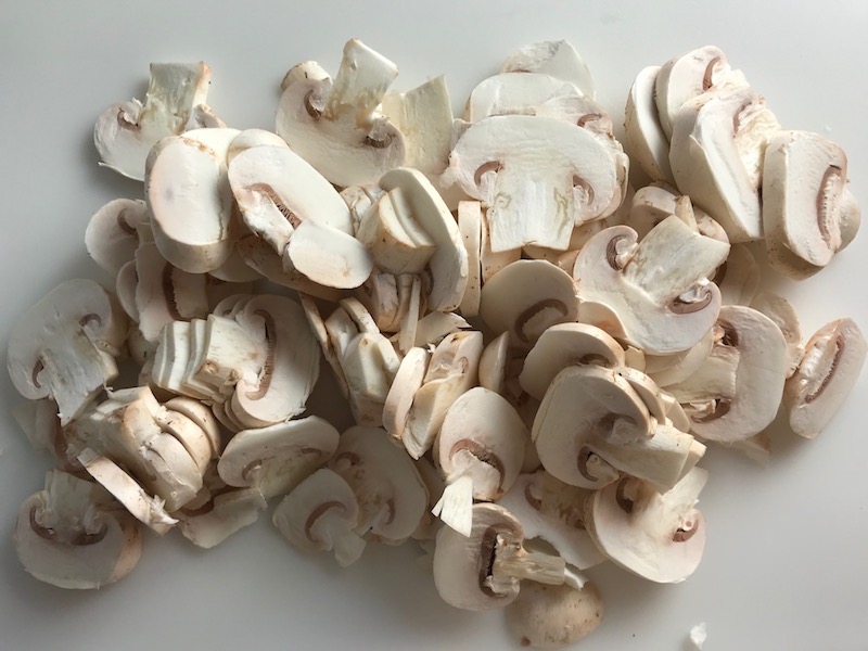 Sliced mushrooms for Chicken Mushroom Stroganoff with spinach. It has a thick, creamy, savory mushroom sauce with a touch of tangy sour cream. #chickendinners #chickenrecipes #familydinners #dinnerideas