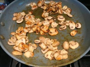 Cooked mushrooms in pan for Chicken Stroganoff with mushrooms, and spinach. It has a thick, creamy, savory mushroom sauce with a touch of tangy sour cream. #chickendinners #chickenrecipes #familydinners #dinnerideas