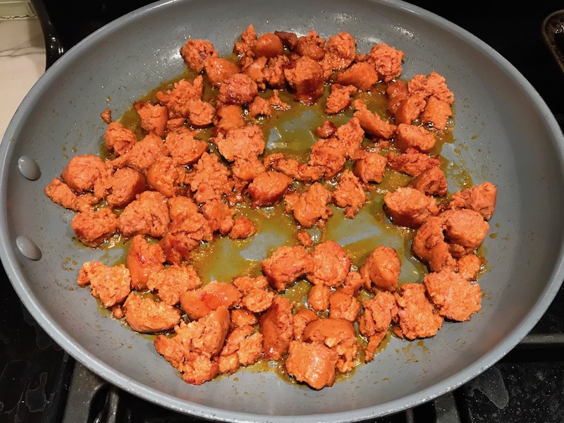 Chorizo in skillet for Patatas Bravas with chorizo and creamy Paprika aioli. This Patatas Bravas Recipe, or Spicy Potatoes, is easy, indulgent, and utterly delicious! #potatorecipes #potatoes #potatosidedishes #patatasbravas #skilletpotatoes #sidedishes #chorizo