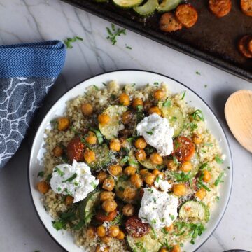 Mediterranean SHEET PAN DINNER on a plate with chicken sausage, parmesan zucchini. and crispy chickpeas over quinoa with dollops of seasoned Ricotta. #sheetpandinner #chickpeas