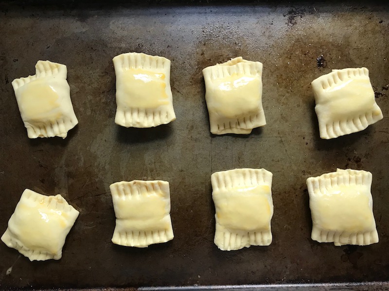 Uncooked Mini Beef Wellington Bites on pan. They are flaky and buttery Puff Pastry is filled with a creamy mushroom and parmesan filling and tender beef filet. #appetizers #partyfood