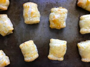 Cooked Mini Beef Wellington Bites on pan. They are flaky and buttery Puff Pastry is filled with a creamy mushroom and parmesan filling and tender beef filet. #appetizers #partyfood