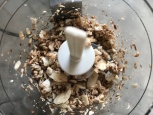 Mushrooms in food processor for Mini Beef Wellington Bites. They are flaky and buttery Puff Pastry is filled with a creamy mushroom and parmesan filling and tender beef filet. #appetizers #partyfood