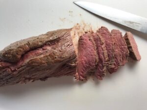 Sliced beef filet for Mini Beef Wellington Bites. They are flaky and buttery Puff Pastry is filled with a creamy mushroom and parmesan filling and tender beef filet. #appetizers #partyfood