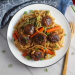 Teriyaki Meatballs with Veggie Stir Fry, and rice noodles on a plate.  #asianmeatballs #teriyaki #noodles #familydinner #easydinners #dinnerideas