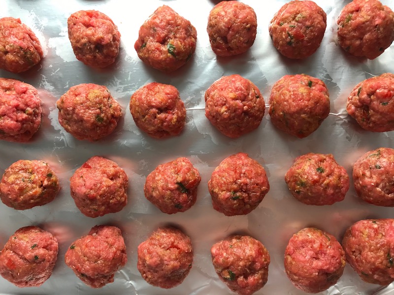 Raw meatballs on pan for Teriyaki Meatballs with Veggie Stir Fry, and rice noodles. #asianmeatballs #teriyaki #noodles #familydinner #easydinners #dinnerideas