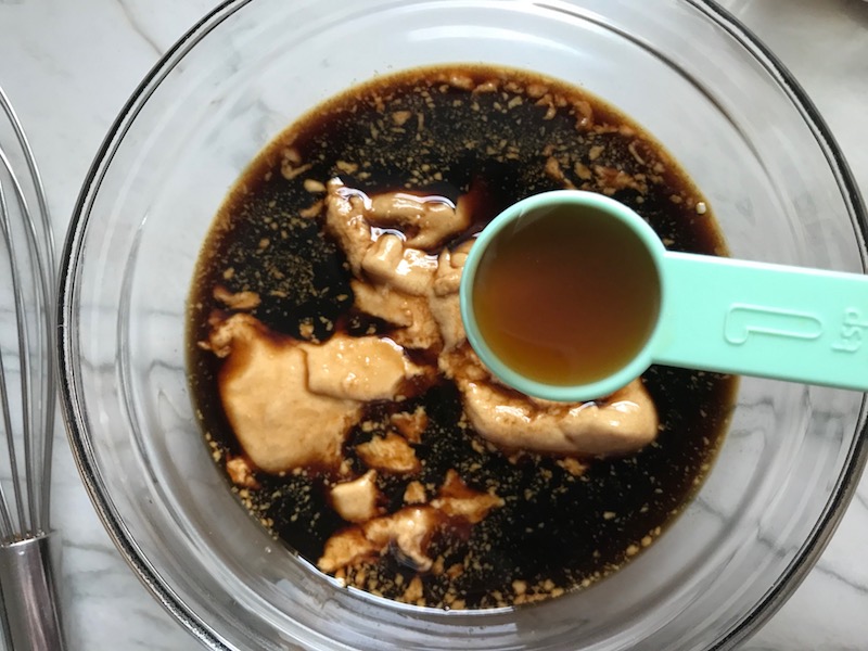 Adding sesame oil to teriyaki & dijon for Teriyaki Meatballs with Veggie Stir Fry, and rice noodles. #asianmeatballs #teriyaki #noodles #familydinner #easydinners #dinnerideas