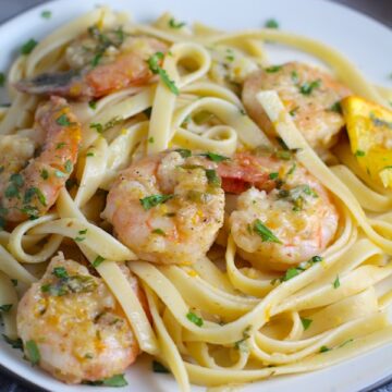 Orange Brown Butter Shrimp Pasta Recipe on a plate. It has a silky sauce that's buttery, nutty, and slightly sweet! #shrimprecipes #shrimppasta #easydinners #dinnerideas 
