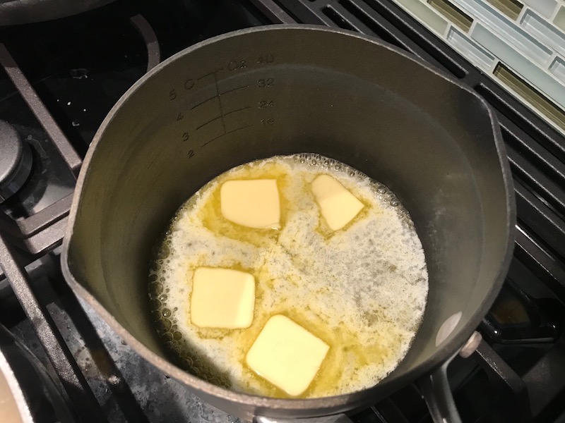 4 tablespoon butter melting in pot for the Orange Brown Butter Shrimp Pasta Recipe. It has a silky sauce that's buttery, nutty, and slightly sweet! #shrimprecipes #shrimppasta #easydinners #dinnerideas