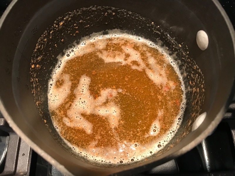 Browned butter in pot for the Orange Brown Butter Shrimp Pasta Recipe. It has a silky sauce that's buttery, nutty, and slightly sweet! #shrimprecipes #shrimppasta #easydinners #dinnerideas