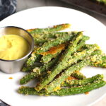 Crispy, crunchy, salty, and addictive!  These are my healthy Crispy Parmesan Green Bean Fries!  Such a great way to transform beans and add a new vegetable into dinner rotation. #vegetablerecipes