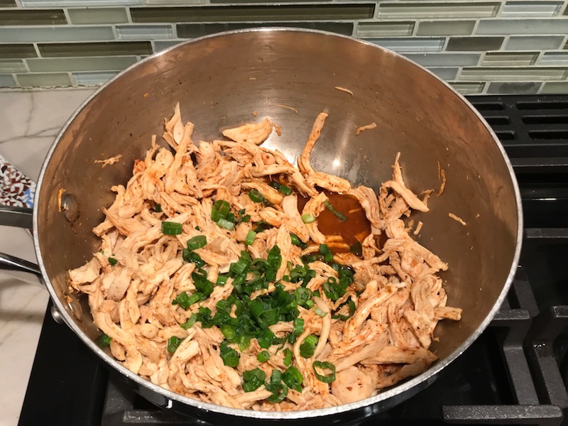 Shredded Chicken mixture for Chicken Taquitos. Corn tortillas are filled with smoky taco seasoned shredded chicken, and creamy cheddar cheese. #dinnerideas #familydinner #chickenrecipes #chickendinner #tacos #taquitos