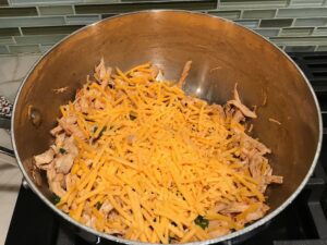 Cheese added to Shredded Chicken mixture for Chicken Taquitos. Corn tortillas are filled with smoky taco seasoned shredded chicken, and creamy cheddar cheese. #dinnerideas #familydinner #chickenrecipes #chickendinner #tacos #taquitos