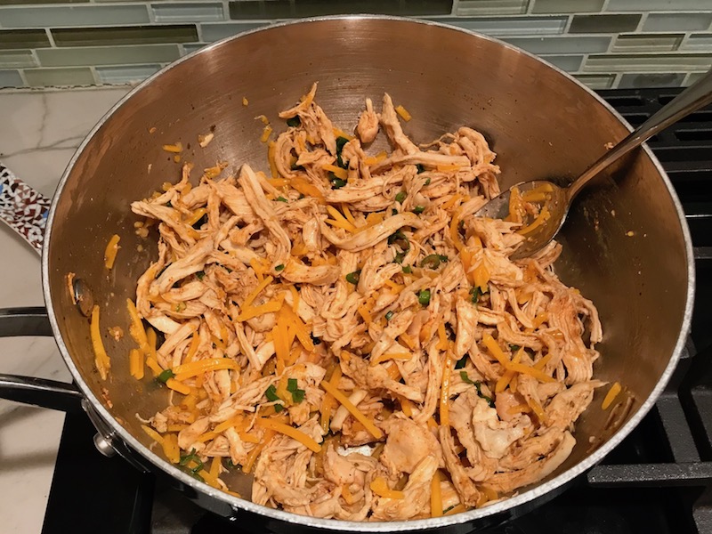 Shredded Chicken mixture for Chicken Taquitos. Corn tortillas are filled with smoky taco seasoned shredded chicken, and creamy cheddar cheese. #dinnerideas #familydinner #chickenrecipes #chickendinner #tacos #taquitos