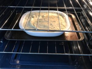 Cottage Pie recipe cooking in oven. It has Spanish Chorizo and ground beef cooked in a rich and savory gravy with veggies and herbs. Creamy mashed potatoes sit on top with manchego, parmesan, and garlic. #dinnerideas #cottagepie #shepherdspie