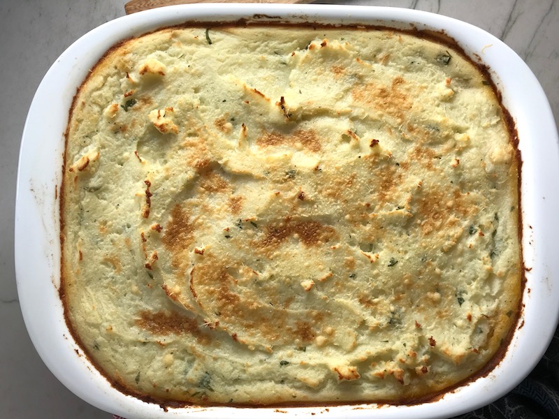 Cooked Cottage Pie recipe. It has Spanish Chorizo and ground beef cooked in a rich and savory gravy with veggies and herbs. Creamy mashed potatoes sit on top with manchego, parmesan, and garlic. #dinnerideas #cottagepie #shepherdspie