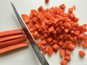 Diced carrots for Cottage Pie recipe. It has Spanish Chorizo and ground beef cooked in a rich and savory gravy with veggies and herbs. Creamy mashed potatoes sit on top with manchego, parmesan, and garlic. #dinnerideas #cottagepie #shepherdspie