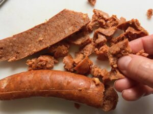 break apart the chorizo for Cottage Pie recipe. It has Spanish Chorizo and ground beef cooked in a rich and savory gravy with veggies and herbs. Creamy mashed potatoes sit on top with manchego, parmesan, and garlic. #dinnerideas #cottagepie #shepherdspie