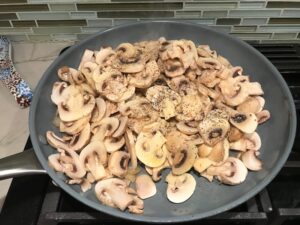 Sliced Mushrooms in skillet for this Heavenly Mushroom Sauce Recipe. #vegetarian #healthydinner #dinnerideas #mushrooms