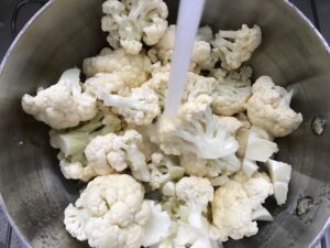 Cauliflower florets in pot for Cauliflower Gnocchi, which are soft, silky, buttery, and melt-in-your-mouth! Made with cauliflower, they're a healthier version to traditional gnocchi! Add my simple Garlic Butter Sauce or Tomato Sauce and they are heaven.  #dinnerideas #gnocchi #cauliflower