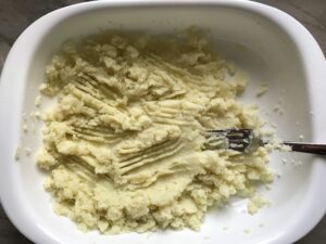 Mashed cauliflower and potato in dish for Cauliflower Gnocchi, which are soft, silky, buttery, and melt-in-your-mouth! Made with cauliflower, they're a healthier version to traditional gnocchi! Add my simple Garlic Butter Sauce or Tomato Sauce and they are heaven.  #dinnerideas #gnocchi #cauliflower