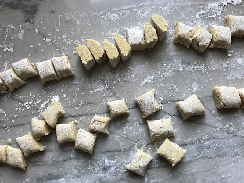 Cut gnocchi on surface for cauliflower gnocchi. These Gnocchi are soft, silky, buttery, and melt-in-your-mouth! Made with cauliflower, they're a healthier version to traditional gnocchi! Add my simple Garlic Butter Sauce or Tomato Sauce and they are heaven. #dinnerideas #gnocchi #cauliflower