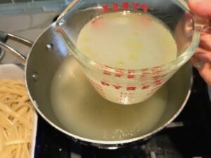 Save 1 cup of pasta water to dish for Bacon Mac and Cheese. It has a creamy and cheesy sauce with a touch of smokiness from the bacon, coats each piece of pasta. On top, crispy crunchy, indulgent bacon fat cracker crumbs!