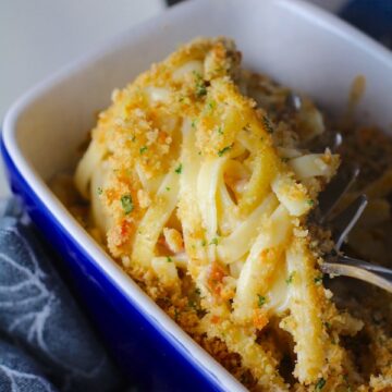 Manchego Mac and Cheese with Bacon scooped up. It has a creamy and cheesy sauce with a touch of smokiness from the bacon, coats each piece of pasta.  On top, crispy crunchy, indulgent bacon fat cracker crumbs!