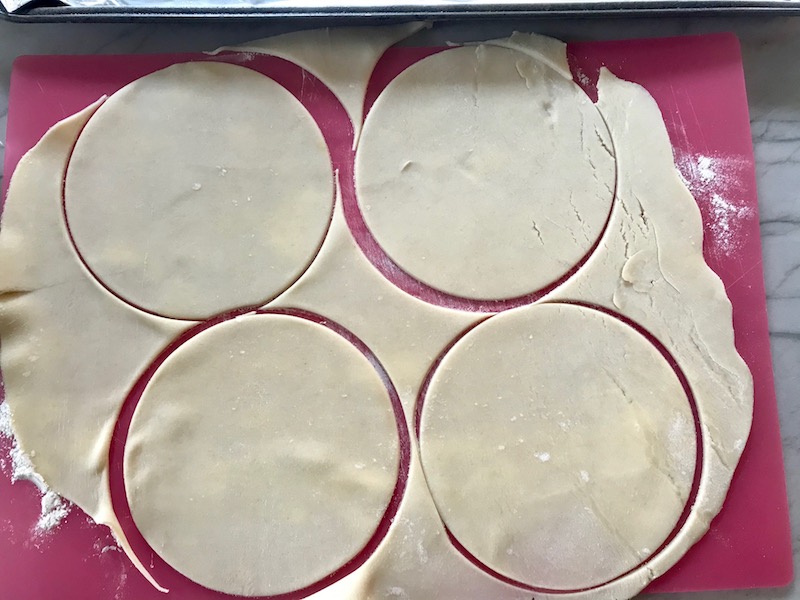 Circles cut into dough for Ground Beef Empanadas. Flaky, buttery pastry on the outside with a savory, smokey, salty ground beef filling.