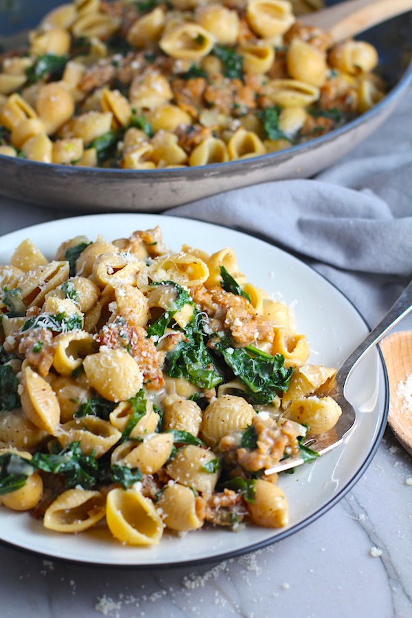 Shell Pasta with Italian Sausage and Kale on a plate. It's loaded with a salty homemade Chicken Italian Sausage flavored with garlic and fennel in a parmesan, garlic and kale sauce.