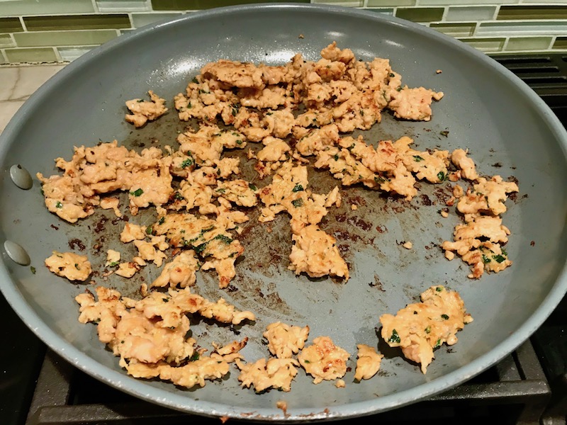 Italian Sausage cooking in pan for Shell Pasta with Italian Sausage and Kale. It's loaded with a salty homemade Chicken Italian Sausage flavored with garlic and fennel in a parmesan, garlic and kale sauce.