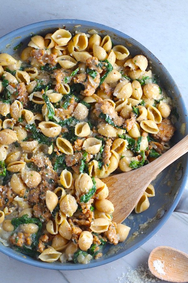 Shell Pasta with Italian Sausage and Kale in a pan. It's loaded with a salty homemade Chicken Italian Sausage flavored with garlic and fennel in a parmesan, garlic and kale sauce.