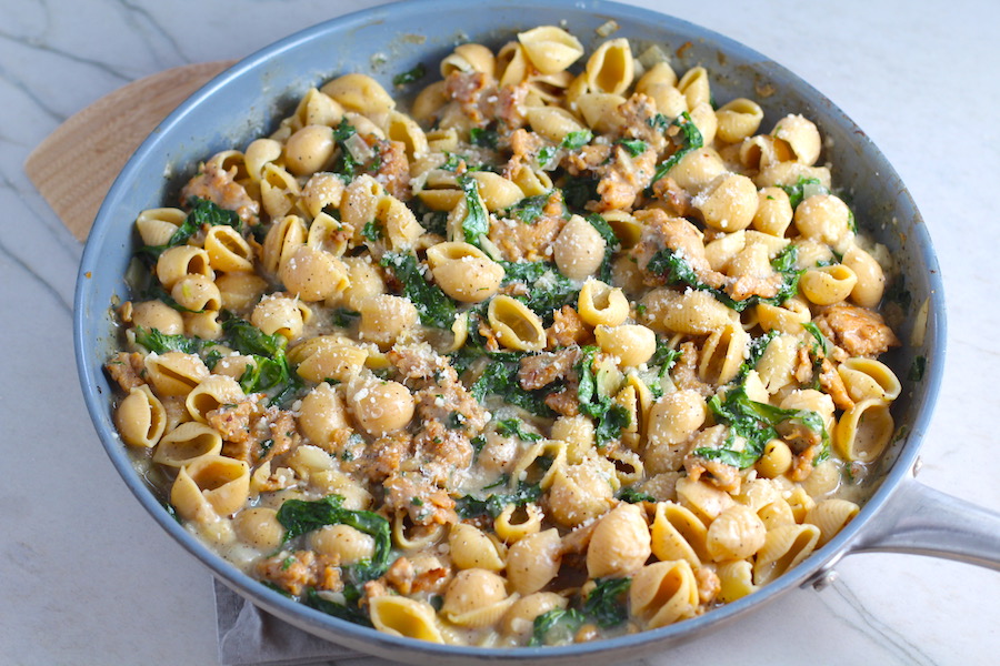 Shell Pasta with Italian Sausage and Kale in a pan. It's loaded with a salty homemade Chicken Italian Sausage flavored with garlic and fennel in a parmesan, garlic and kale sauce.