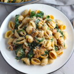 Italian Chicken Sausage Pasta with Kale on a plate. It's loaded with a salty homemade Chicken Italian Sausage flavored with garlic and fennel in a parmesan, garlic and kale sauce. 