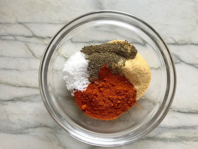 Spice Rub spices for Spanish Chicken and Rice. It's hearty, smokey, and delicious! Paprika spice blend rubbed chicken thighs are seared then cooked with rice, onions, carrots, garlic, tomatoes, and olives for unbelievable flavor! #easydinners #chickenrecipes