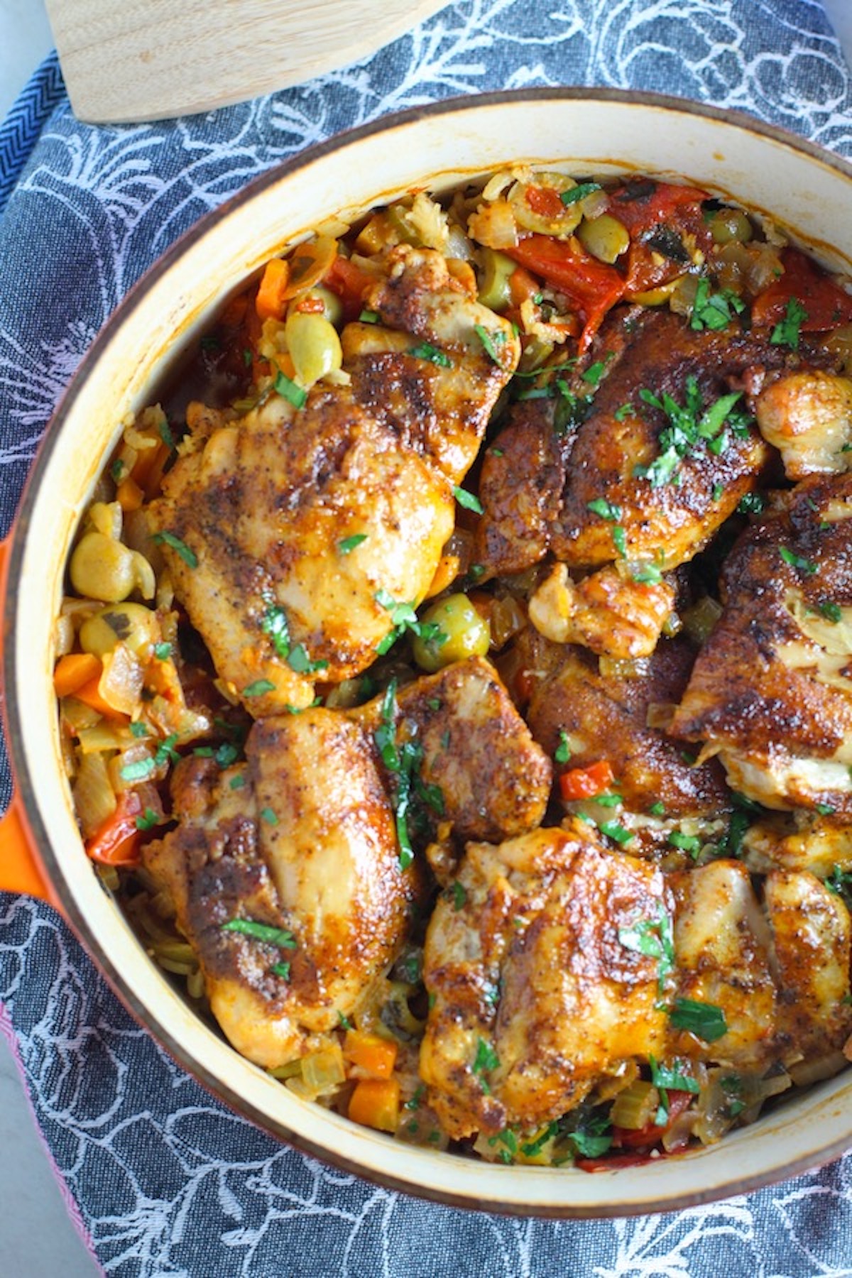 Spanish Chicken and Rice in a pot on a blue towel. It's hearty, smokey, and delicious!