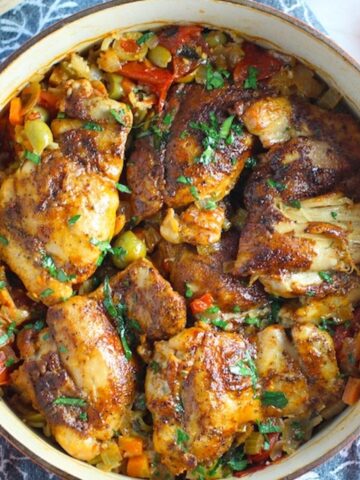 Spanish Chicken and Rice in a pot on a blue towel. It's hearty, smokey, and delicious!