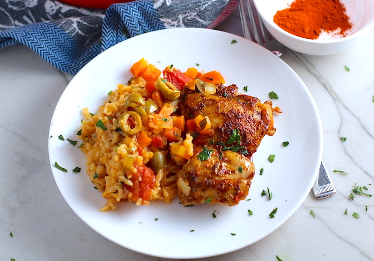 Spanish Chicken and Rice on plate with fork. It's hearty, smokey, and delicious!