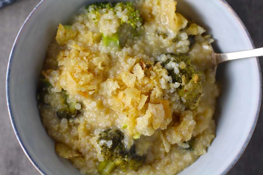 Broccoli Cheese Quinoa Bake in a bowl with potato chips on top. It's a comfy cozy casserole that's perfect to make ahead for a simple weeknight side or main dish.
