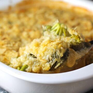 Spoon scooping Broccoli Cheese Quinoa Bake with potato chips on top. It's a comfy cozy casserole that's perfect to make ahead for a simple weeknight side or main dish.