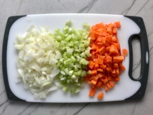 Diced onion, celery, and carrots Chili Mac and Cheese. This Recipe has creamy and cheesy pasta topped with smokey, tangy, savory beef chili! #macandcheese #chilirecipes