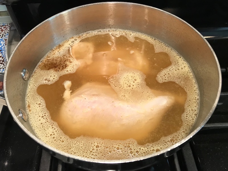 Chicken boiling for Creamy Chicken Enchilada Soup. It's creamy, hearty, slightly spicy with green chiles and smokey seasonings that bring so much depth. Corn tortilla strips act like the noodles in this soup!