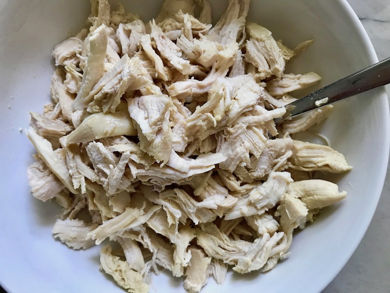 Shredded chicken for Creamy Chicken Enchilada Soup. It's creamy, hearty, slightly spicy with green chiles and smokey seasonings that bring so much depth. Corn tortilla strips act like the noodles in this soup!