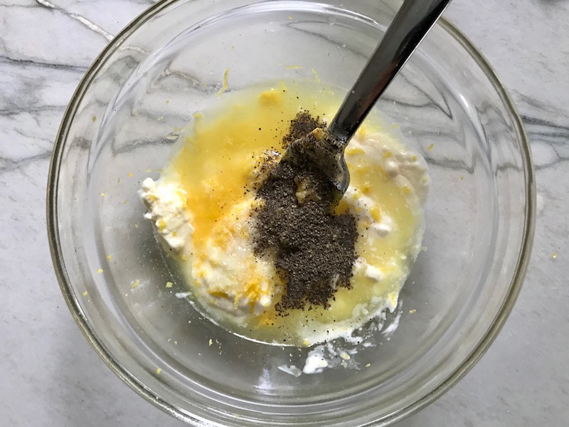Ingredients in bowl for Lemon dressing for Greek Orzo Salad with Kalamata Olives, Cucumbers, and Feta Cheese.