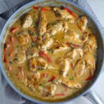 Tarragon Mustard Sauce for Chicken Without Cream with red peppers in a pan on towel on counter. It gets so much flavor from dijon mustard, tarragon, garlic, and onion. It's an easy-to-whip-up any night dinner!