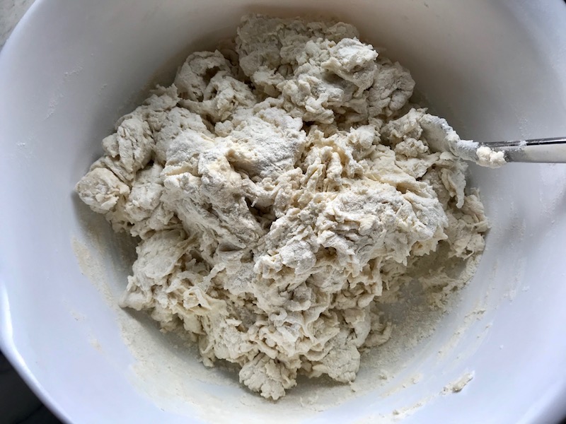 homemade pizza dough being mixed in a bowl for a BBQ Chicken Pizza Recipe