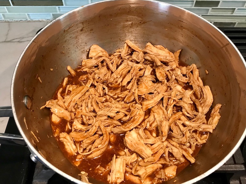 Shredded BBQ chicken in pot for a BBQ Chicken Pizza Recipe