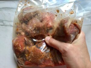 Raw beef cubes in bag with marinade for Garlic Steak Kabobs. #beefkabobs #steakkabobs